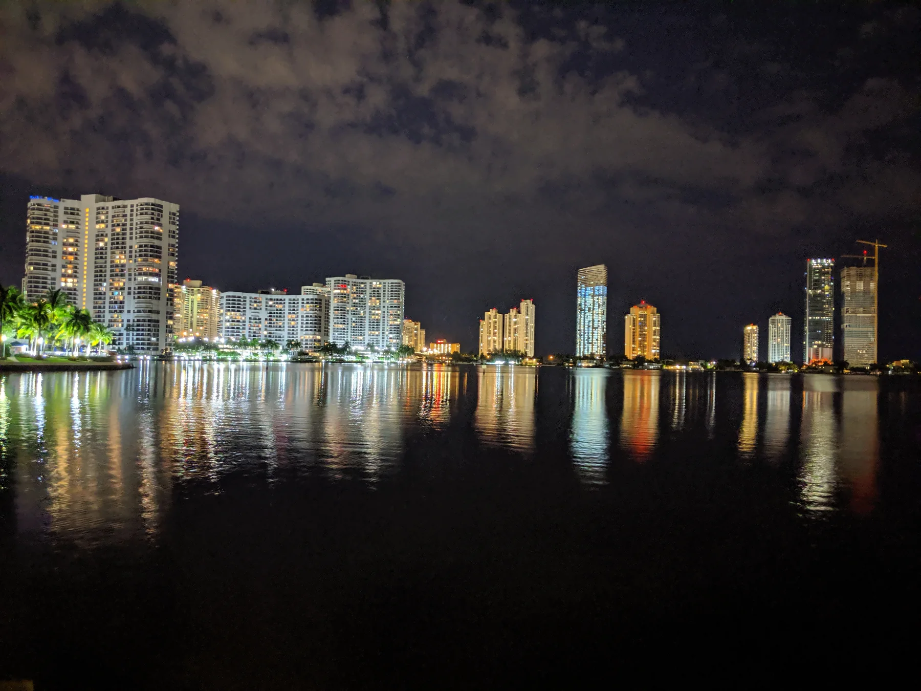 Aventura waterfront buildings reflected in the water at night